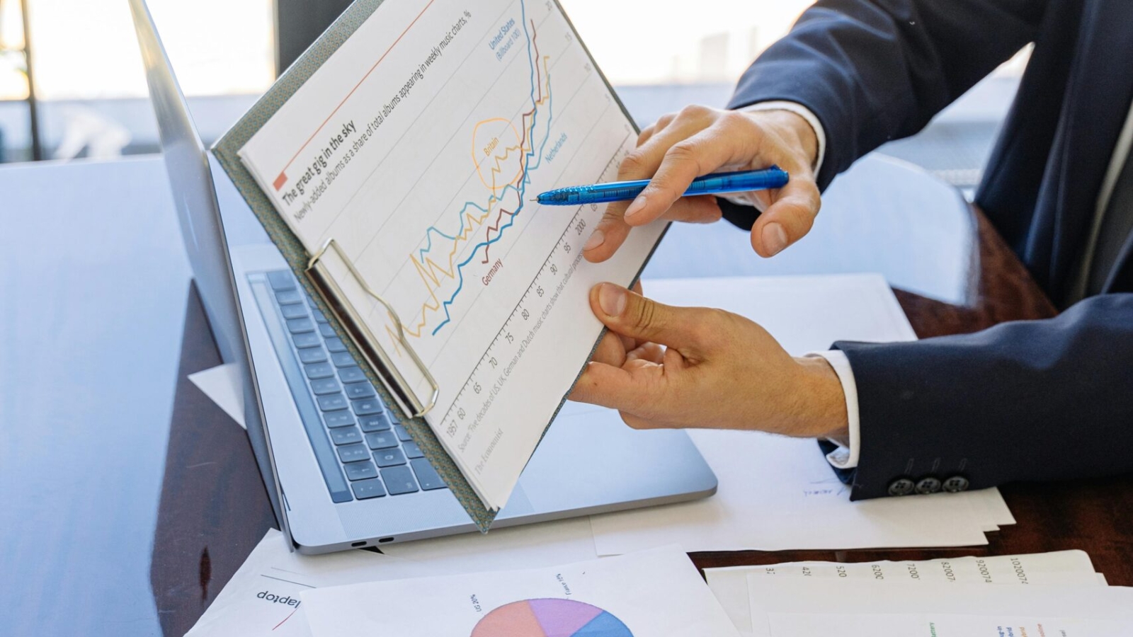 Free Business professionals discussing financial graphs and charts in an office setting. Stock Photo