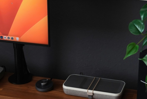 a desk with a laptop, keyboard, mouse and a monitor